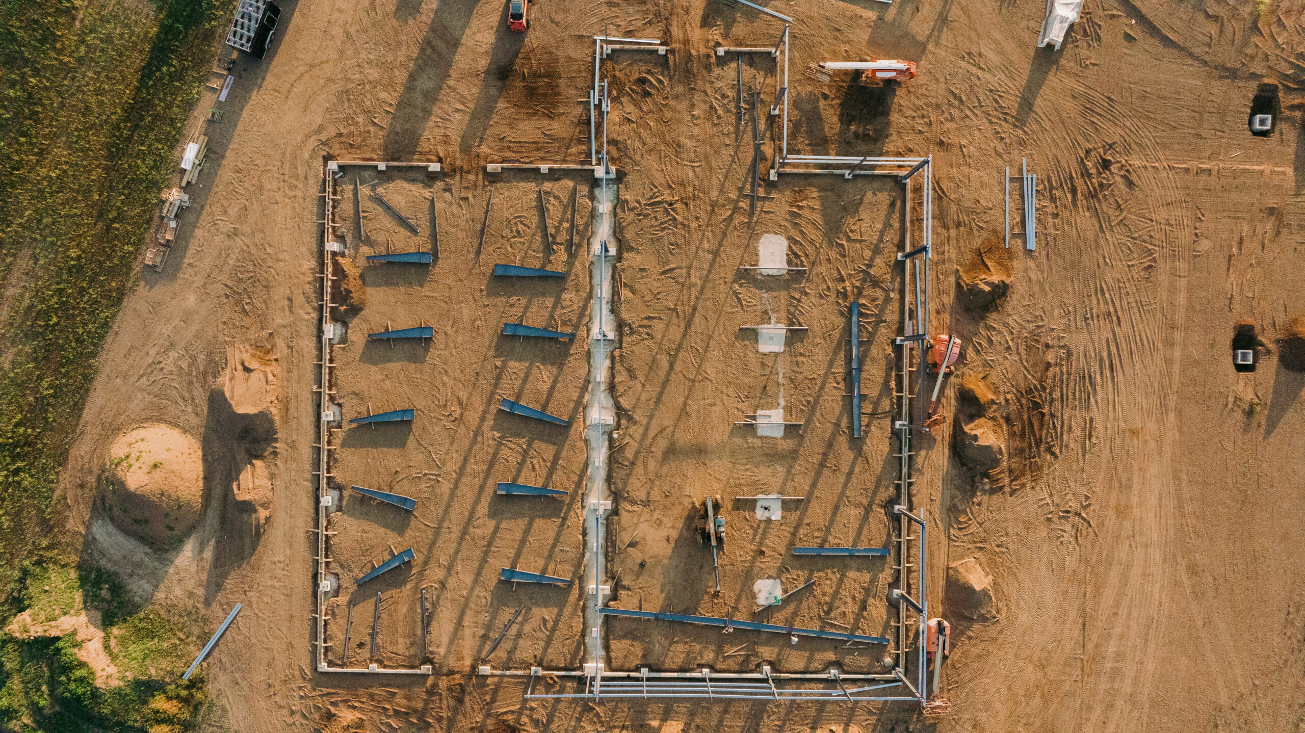 Construction site with building foundation and framing in progress.