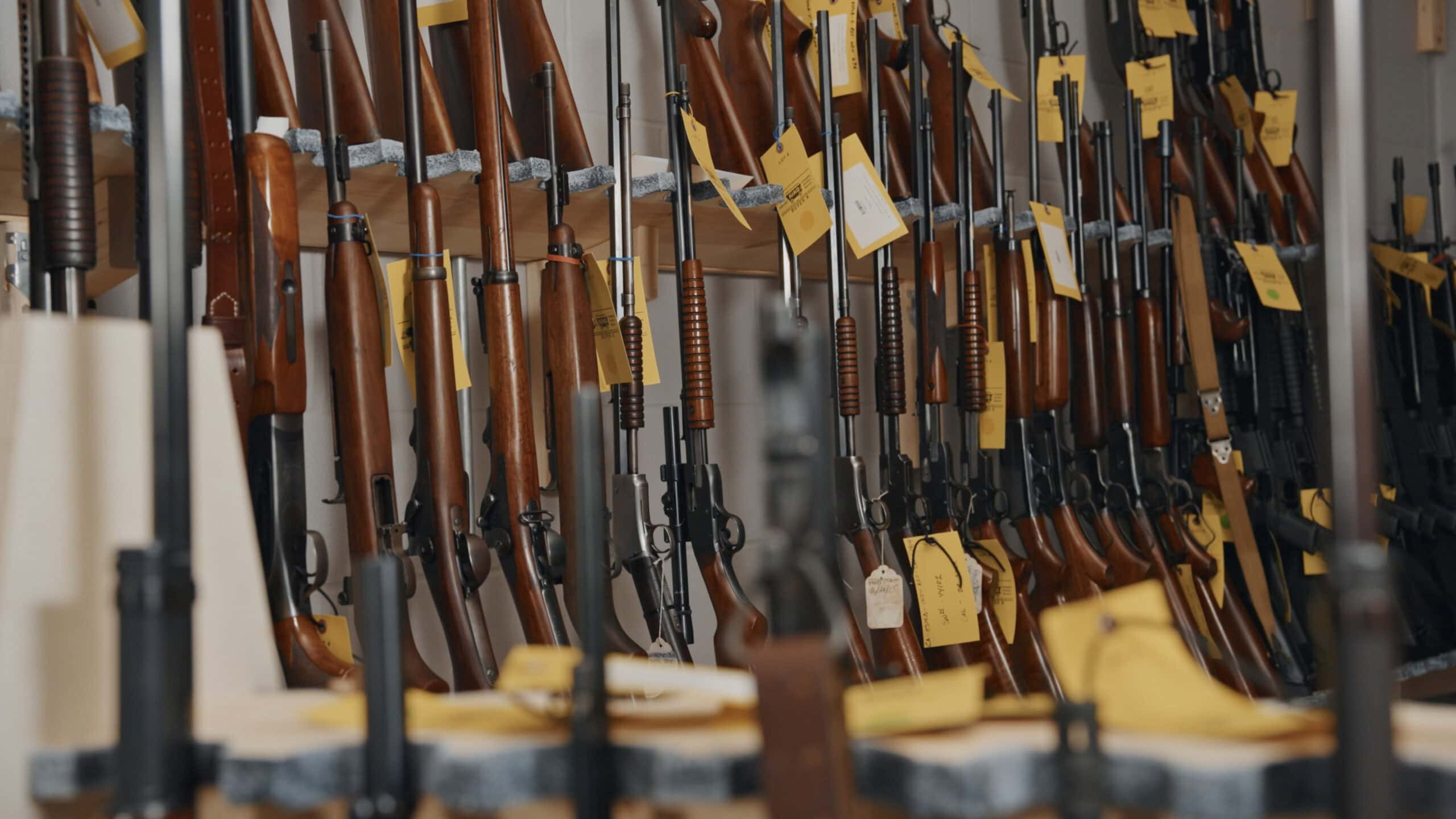 KIKO Work Firearms lined up with lot tags for a KIKO Auctions sale